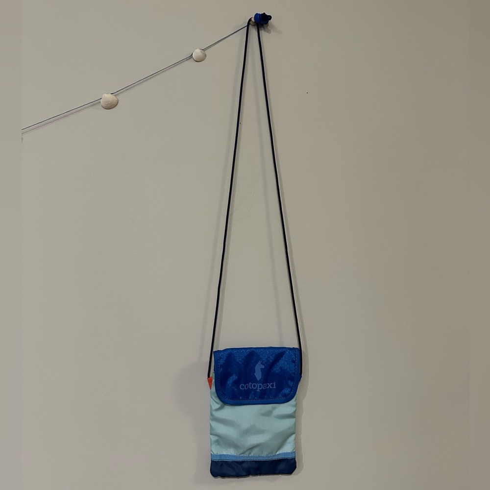 Blue multicolored Cotopaxi crossbody traveling purse. Never used.